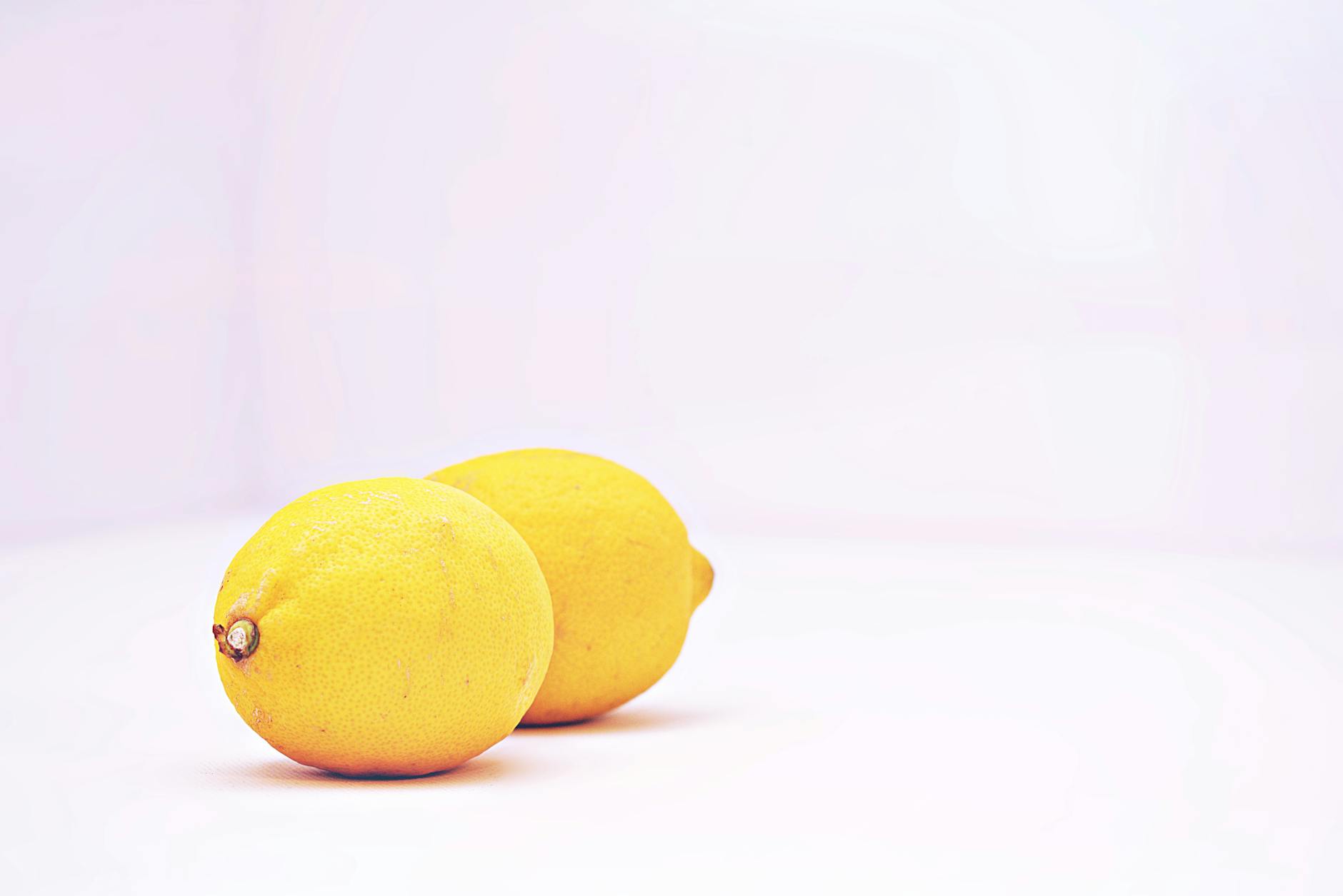 Colorful silicone clitoral vibrators arranged on a bright yellow background
