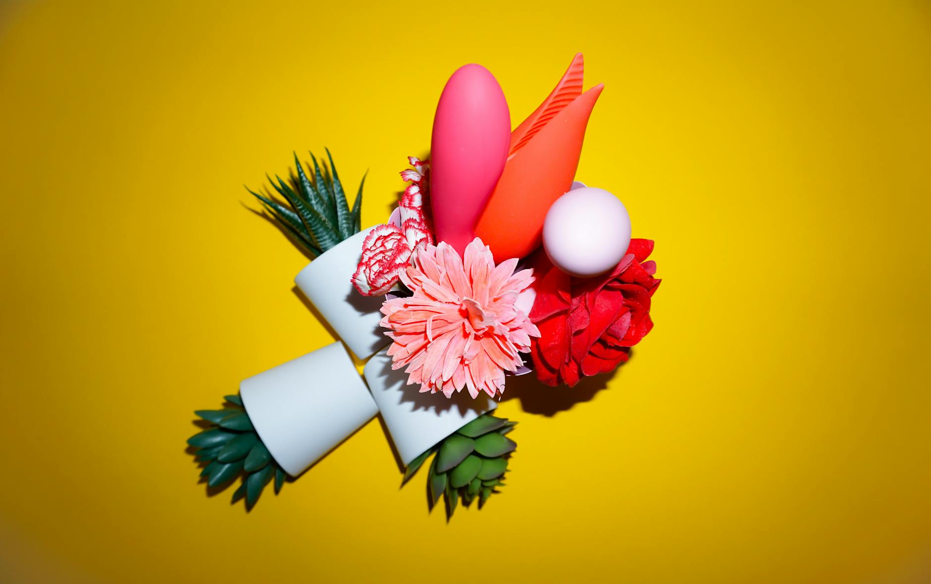 Fresh lemons on white plate against yellow background representing citrus-inspired pleasure toys