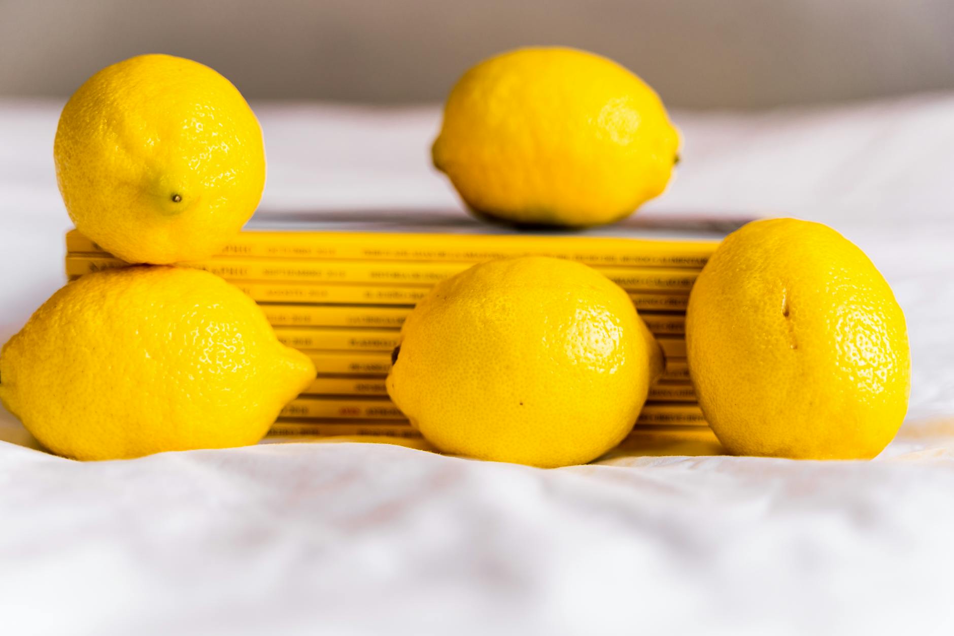 Fresh ripe lemons on a bright yellow background in natural daylight